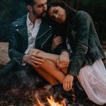 photo by laure rader via unsplash - romantic couple by a camp fire