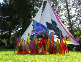 stained glass dragon in front of tepee